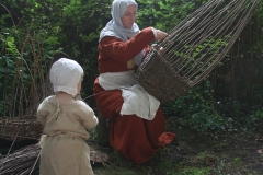 Basket weaving, as daughter watches