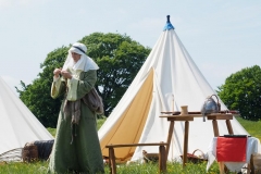 Using a drop spindle at Old Sarum